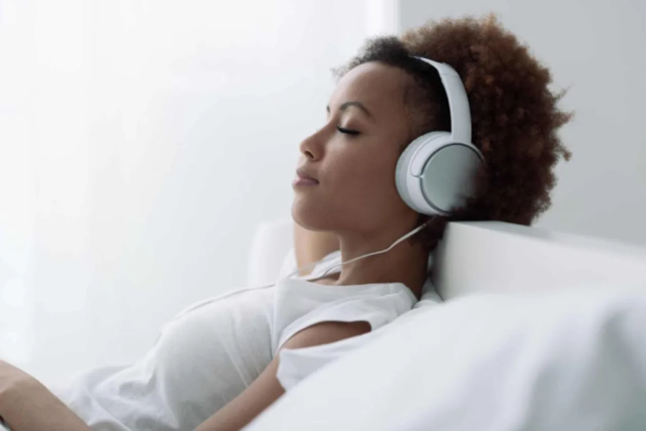woman wearing headphones listening to sleep ASMR